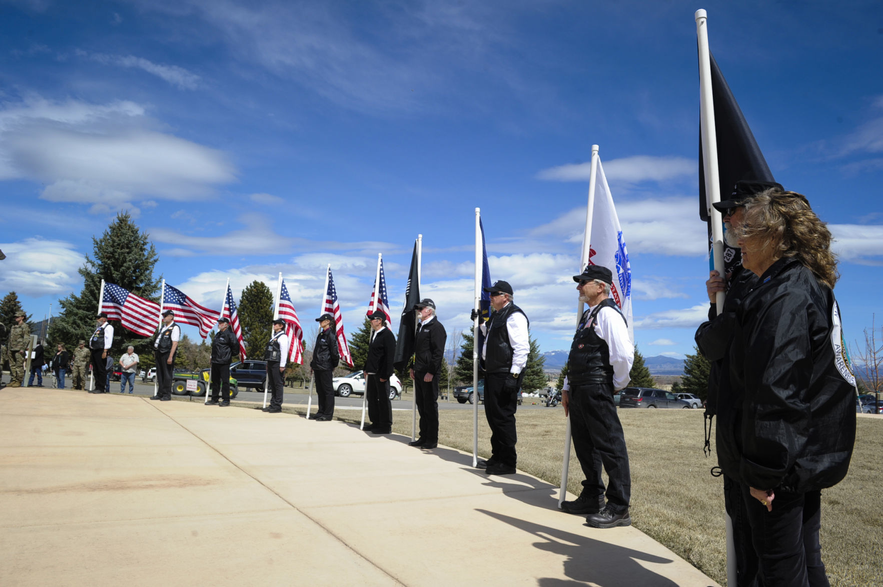 Members of the Montana POW/MIA Awareness Association hold flags